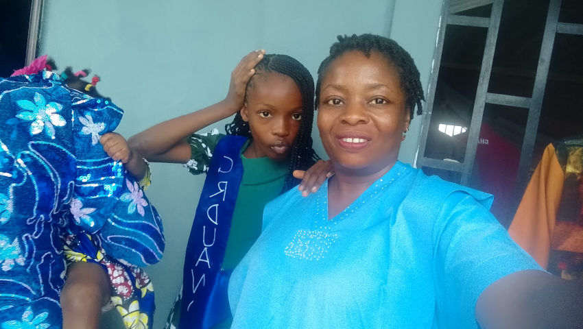 Mom and daughter dancing inside the graduation hall